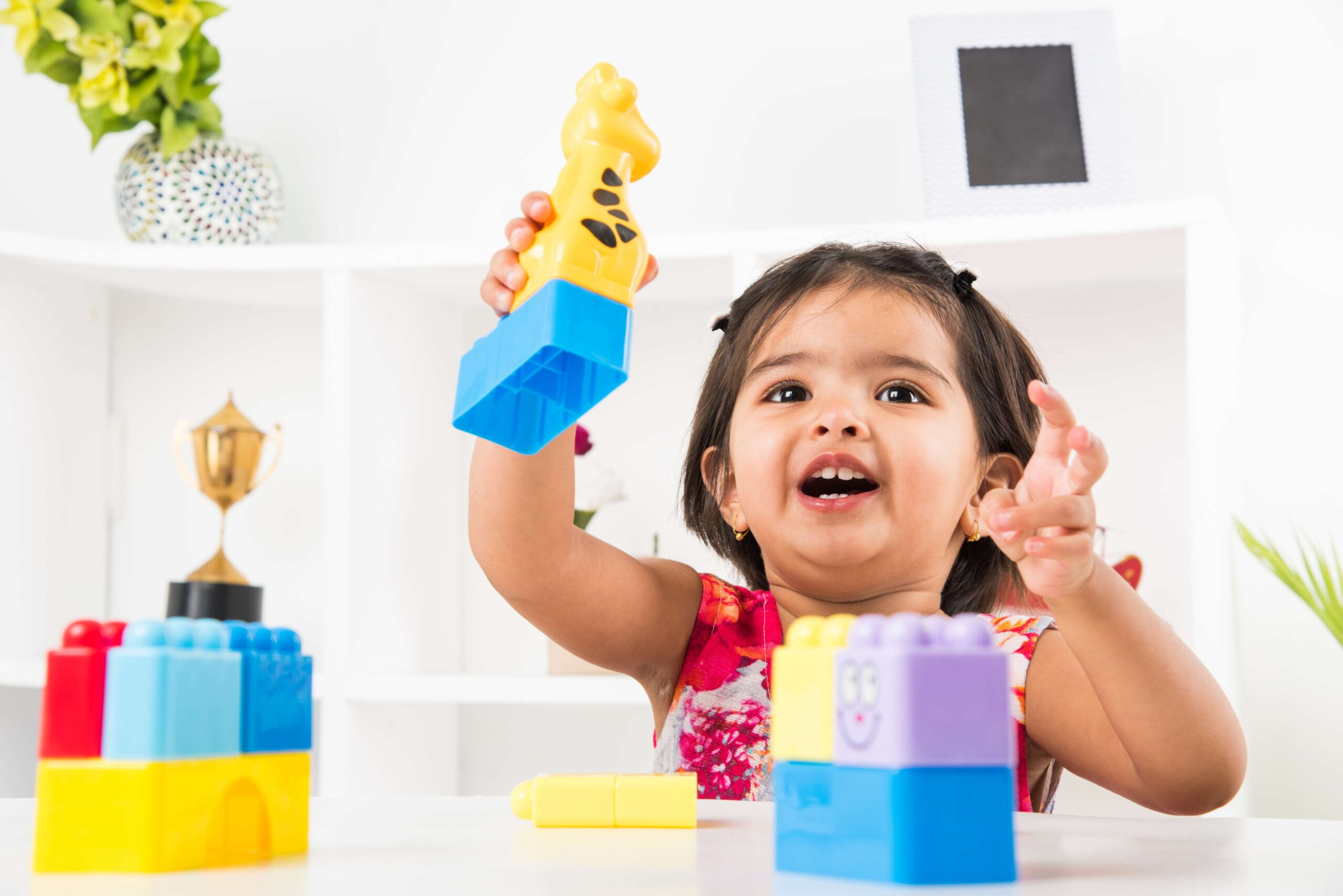 cute-little-indian-asian-girl-enjoying-while-playing-with-toys-blocks-sitting-table (1)